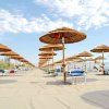 Ombrelloni di paglia su una spiaggia sabbiosa.